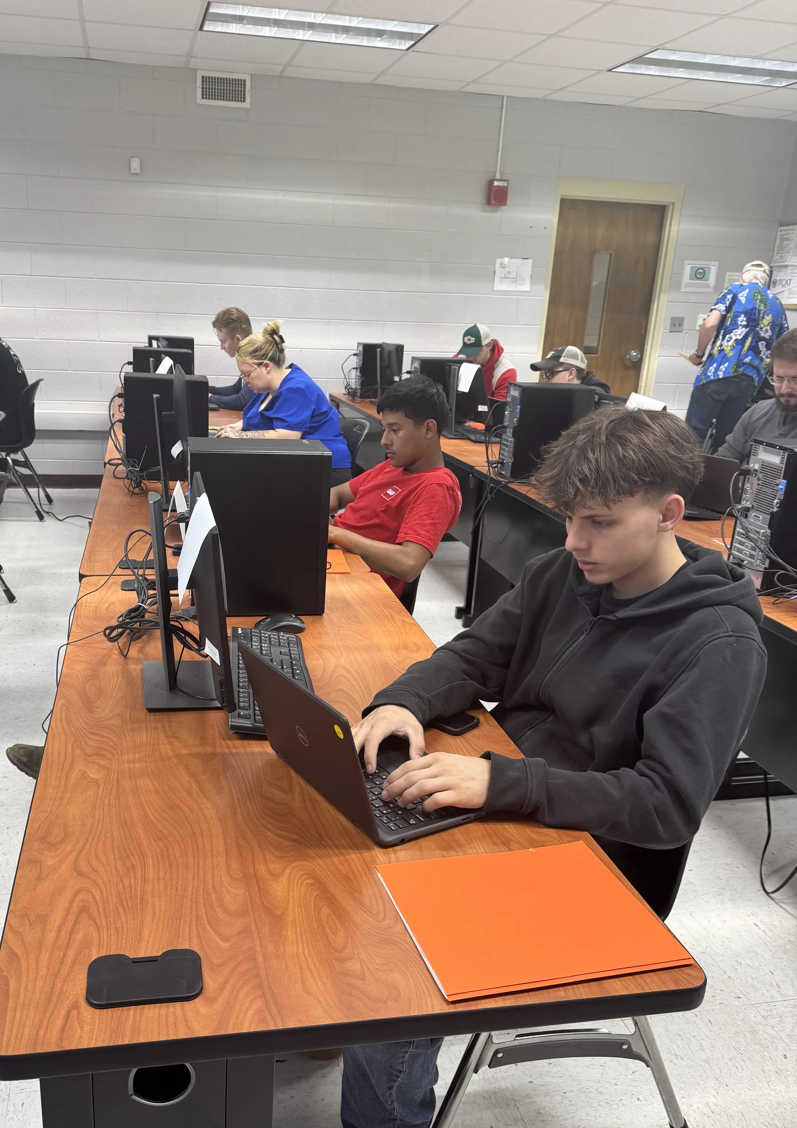Students working closely with an instructor in a Tech 4 All Tennessee workforce-readiness class